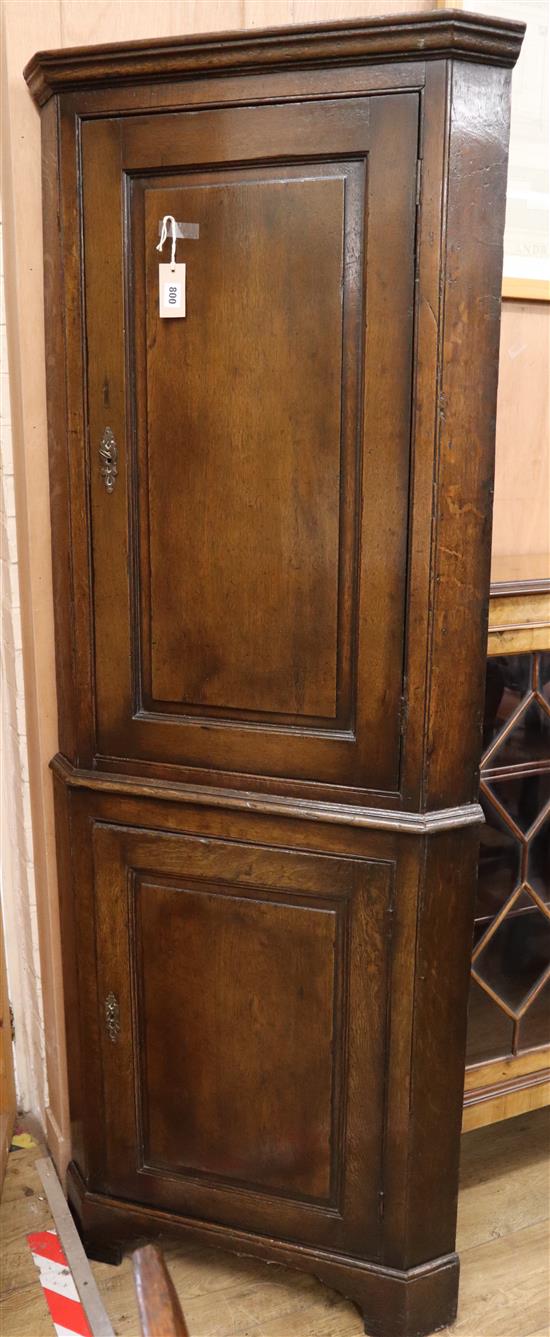 An 18th century panelled oak two-door standing corner cupboard H.188cm